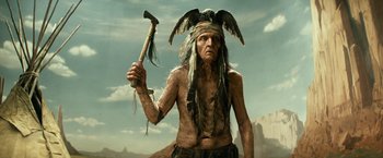 Movie still from “The Lone Ranger” (2013), directed by Gore Verbinski – An old indian holding an axe in his hand; Medium shot, Low angle