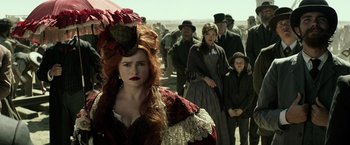 Movie still from “The Lone Ranger” (2013), directed by Gore Verbinski – A group of people standing in a field with a woman with red hair; Medium shot, Over the shoulder angle