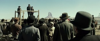 Movie still from “The Lone Ranger” (2013), directed by Gore Verbinski – A group of people standing in front of a mountain; Wide shot, Low angle