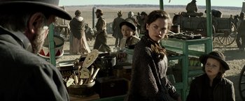 Movie still from “The Lone Ranger” (2013), directed by Gore Verbinski – A woman standing in front of other people; Medium shot, Over the shoulder angle