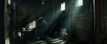 Movie still from “The Lone Ranger” (2013), directed by Gore Verbinski – A man kneeling down in a dark room; Wide shot, High angle