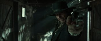 Movie still from “The Lone Ranger” (2013), directed by Gore Verbinski – A man in a black hat and a black suit; Close Up shot, Over the shoulder angle