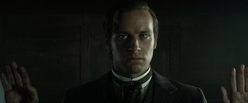 Movie still from “The Lone Ranger” (2013), directed by Gore Verbinski – A person wearing a suit and tie; Close Up shot, Low angle