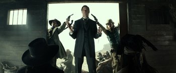 Movie still from “The Lone Ranger” (2013), directed by Gore Verbinski – A group of men standing next to each other holding guns; Medium shot, Low angle
