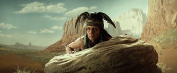 Movie still from “The Lone Ranger” (2013), directed by Gore Verbinski – An old native american man with a bird on his head; Medium shot, Low angle