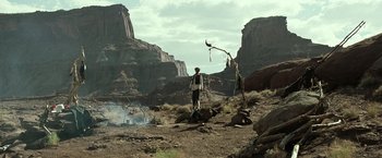 Movie still from “The Lone Ranger” (2013), directed by Gore Verbinski – A man standing on top of a hill next to rocks; Extreme Wide shot, Low angle