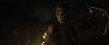 Movie still from “The Lone Ranger” (2013), directed by Gore Verbinski – An old man dressed as an indian with a hawk on his head; Close Up shot, Low angle
