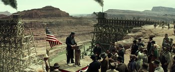 Movie still from “The Lone Ranger” (2013), directed by Gore Verbinski – A man in a top hat is speaking to a group of people; Extreme Wide shot, Low angle