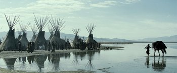 Movie still from “The Lone Ranger” (2013), directed by Gore Verbinski – A group of people standing next to a body of water; Extreme Wide shot, Low angle