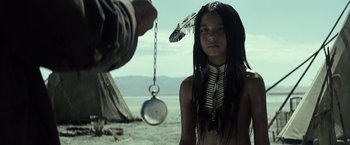 Movie still from “The Lone Ranger” (2013), directed by Gore Verbinski – A native american girl standing in front of a man holding a clock; Close Up shot, Over the shoulder angle