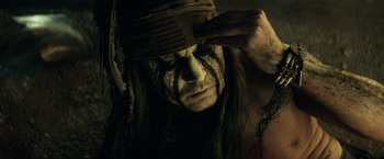Movie still from “The Lone Ranger” (2013), directed by Gore Verbinski – A person wearing a headdress; Close Up shot, Low angle