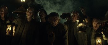 Movie still from “The Lone Ranger” (2013), directed by Gore Verbinski – A group of people standing in a dark room; Medium shot, Low angle
