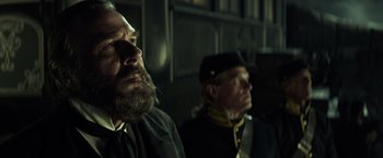 Movie still from “The Lone Ranger” (2013), directed by Gore Verbinski – Two men in civil war garb sitting next to each other; Close Up shot, Low angle