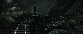 Movie still from “The Lone Ranger” (2013), directed by Gore Verbinski – A man standing on top of a train track; Extreme Wide shot, High angle