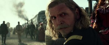 Movie still from “The Lone Ranger” (2013), directed by Gore Verbinski – A person with long hair and a beard; Close Up shot, Over the shoulder angle