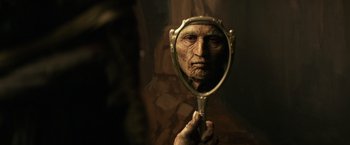 Movie still from “The Lone Ranger” (2013), directed by Gore Verbinski – An old man looking into a mirror with a creepy look on his face; Extreme Close Up shot, Over the shoulder angle