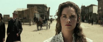 Movie still from “The Lone Ranger” (2013), directed by Gore Verbinski – A woman standing in front of a horse drawn carriage; Close Up shot, Low angle