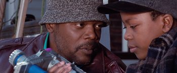 Movie still from “The Long Kiss Goodnight” (1996), directed by Renny Harlin – A person wearing a hat; Close Up shot, Over the shoulder angle