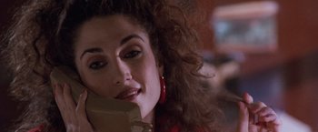 Movie still from “The Long Kiss Goodnight” (1996), directed by Renny Harlin – A person talking on a cell phone; Close Up shot, Overhead angle