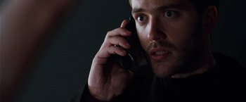 Movie still from “The Long Kiss Goodnight” (1996), directed by Renny Harlin – A person talking on a cell phone; Close Up shot, Low angle