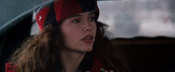 Movie still from “The Long Kiss Goodnight” (1996), directed by Renny Harlin – A person wearing a hat and looking to the side; Close Up shot, Over the shoulder angle