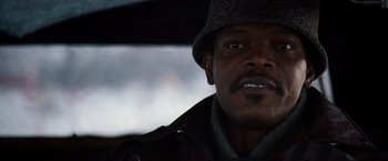 Movie still from “The Long Kiss Goodnight” (1996), directed by Renny Harlin – A person wearing a hat and jacket; Close Up shot, Low angle