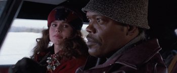 Movie still from “The Long Kiss Goodnight” (1996), directed by Renny Harlin – A man and a woman are sitting in a car; Close Up shot, Over the shoulder angle
