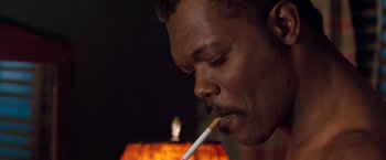 Movie still from “The Long Kiss Goodnight” (1996), directed by Renny Harlin – A person lighting a cigarette; Close Up shot, Low angle