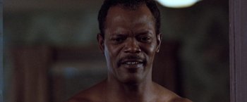 Movie still from “The Long Kiss Goodnight” (1996), directed by Renny Harlin – A man's face in a dark room; Close Up shot, Low angle