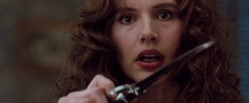Movie still from “The Long Kiss Goodnight” (1996), directed by Renny Harlin – A person holding a pair of scissors; Close Up shot, Low angle