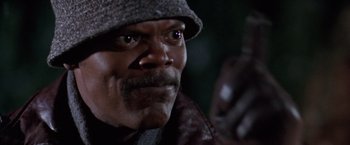 Movie still from “The Long Kiss Goodnight” (1996), directed by Renny Harlin – A person wearing a hat and jacket; Close Up shot, Low angle