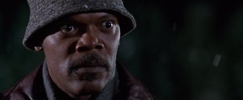 Movie still from “The Long Kiss Goodnight” (1996), directed by Renny Harlin – A person wearing a hat and jacket; Close Up shot, Low angle