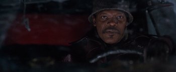 Movie still from “The Long Kiss Goodnight” (1996), directed by Renny Harlin – A person wearing a hat and jacket; Close Up shot, High angle