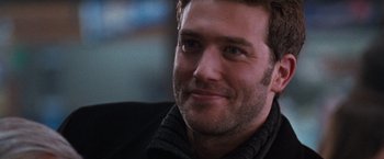 Movie still from “The Long Kiss Goodnight” (1996), directed by Renny Harlin – A man's face in a black jacket; Close Up shot, Over the shoulder angle