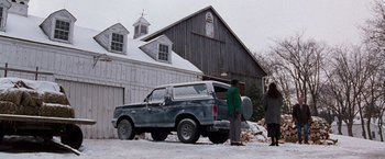 Movie still from “The Long Kiss Goodnight” (1996), directed by Renny Harlin – An old truck parked in front of an old barn; Extreme Wide shot, Low angle