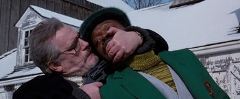 Movie still from “The Long Kiss Goodnight” (1996), directed by Renny Harlin – A man holding on to another man with a gun in his hand; Close Up shot, High angle