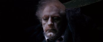 Movie still from “The Long Kiss Goodnight” (1996), directed by Renny Harlin – A man with a white beard and a mustache; Close Up shot, High angle