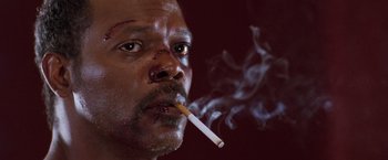 Movie still from “The Long Kiss Goodnight” (1996), directed by Renny Harlin – A person smoking a cigarette; Close Up shot, Low angle