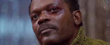 Movie still from “The Long Kiss Goodnight” (1996), directed by Renny Harlin – A man's face with bruises on his face; Close Up shot, Low angle
