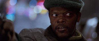 Movie still from “The Long Kiss Goodnight” (1996), directed by Renny Harlin – A person wearing a hat; Close Up shot, Low angle