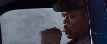 Movie still from “The Long Kiss Goodnight” (1996), directed by Renny Harlin – A man with a cigarette in his mouth in a car; Close Up shot, Low angle
