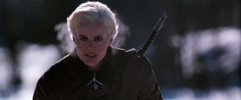 Movie still from “The Long Kiss Goodnight” (1996), directed by Renny Harlin – A woman holding a sword in her hand; Close Up shot, Low angle