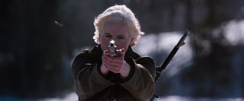 Movie still from “The Long Kiss Goodnight” (1996), directed by Renny Harlin – A woman holding a gun in her hands; Close Up shot, Low angle