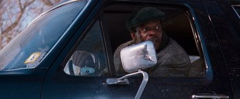 Movie still from “The Long Kiss Goodnight” (1996), directed by Renny Harlin – A man in a car looking out of the window; Close Up shot, Low angle