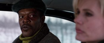 Movie still from “The Long Kiss Goodnight” (1996), directed by Renny Harlin – A person holding an open umbrella; Close Up shot, Over the shoulder angle