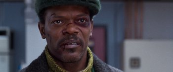 Movie still from “The Long Kiss Goodnight” (1996), directed by Renny Harlin – A person wearing a hat; Close Up shot, Over the shoulder angle