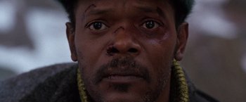 Movie still from “The Long Kiss Goodnight” (1996), directed by Renny Harlin – A man's face with bruises on his face; Close Up shot, High angle