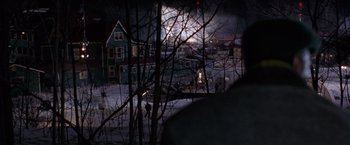Movie still from “The Long Kiss Goodnight” (1996), directed by Renny Harlin – A view of a city at night through a window; Extreme Wide shot, Over the shoulder angle