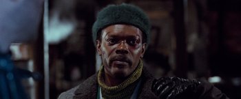 Movie still from “The Long Kiss Goodnight” (1996), directed by Renny Harlin – A person wearing a green hat; Close Up shot, Low angle