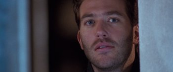 Movie still from “The Long Kiss Goodnight” (1996), directed by Renny Harlin – A man's face in a dark room; Close Up shot, Over the shoulder angle